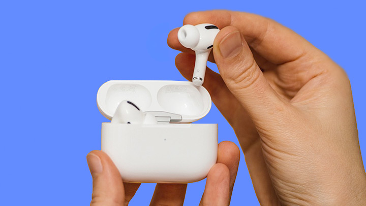 Hands holding AirPods