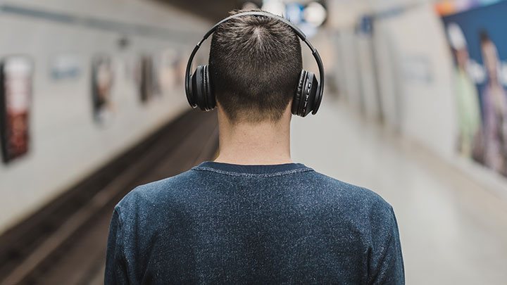Man wearing headphones subway
